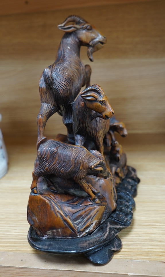 A Chinese carved soapstone figure group of goats on hardwood base, 24cm. Condition - fair to good